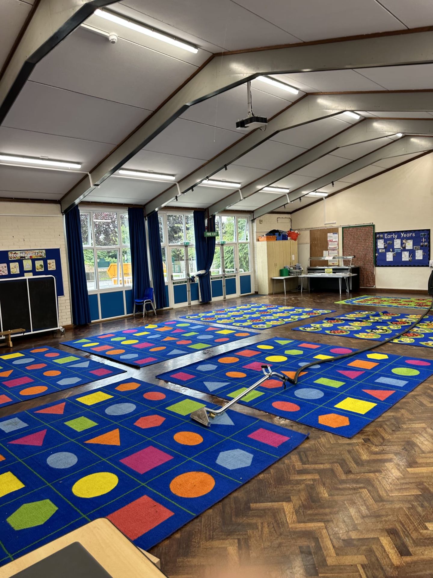 School play mats professionally cleaned in hall with commercial extraction equipment