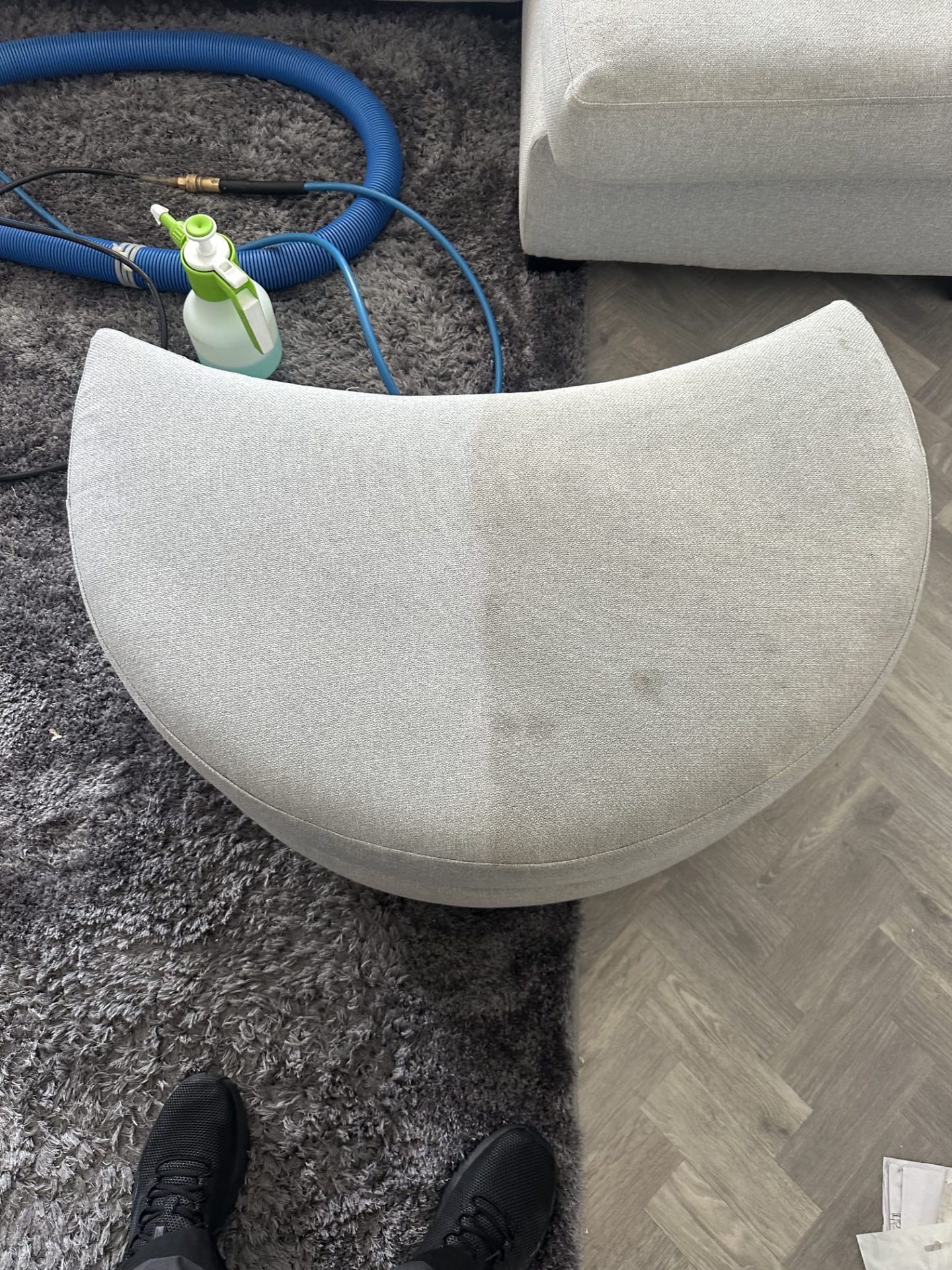 Sofa cushion with stain being treated with professional cleaning solution